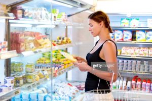 woman buys cheese in the supermarket